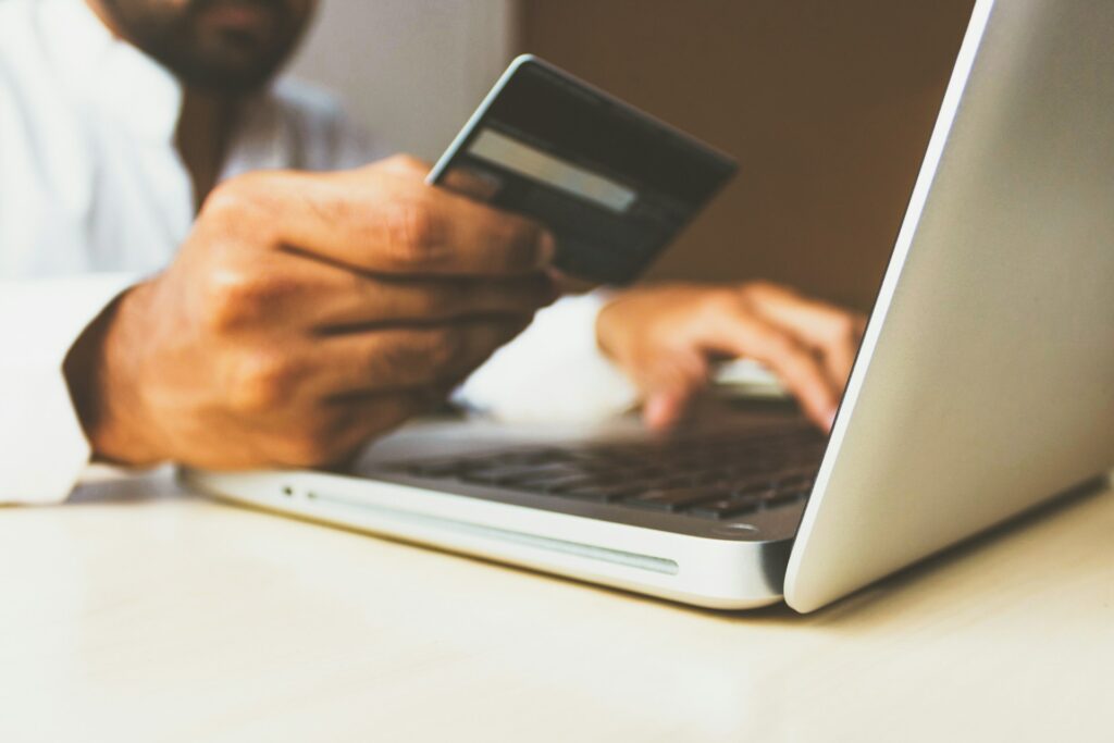 Man entering credit card payment details into website.